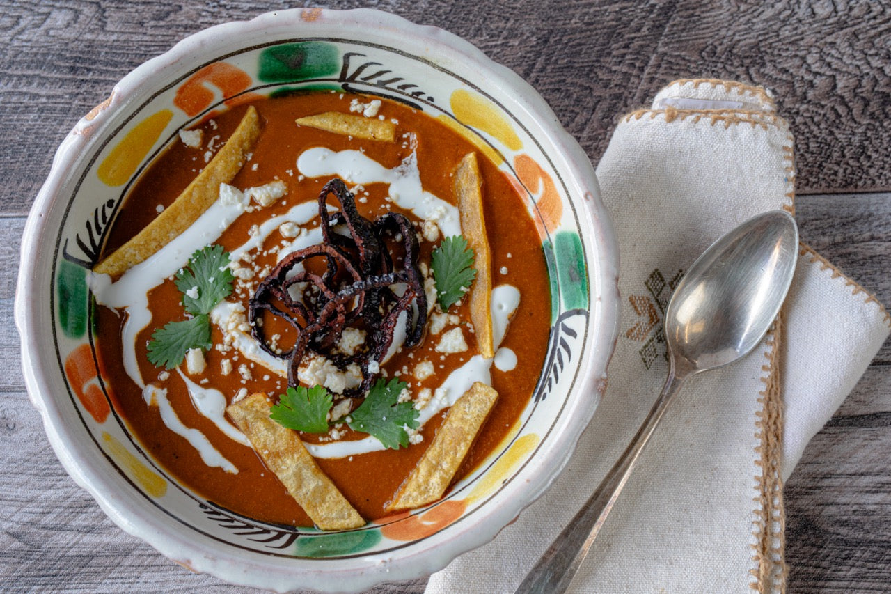 Tarascan Bean Soup in serving bowl with fried chiles, sour cream and tortilla strips
