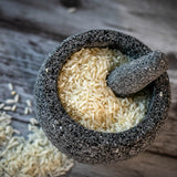 Small molcajete with uncooked rice.