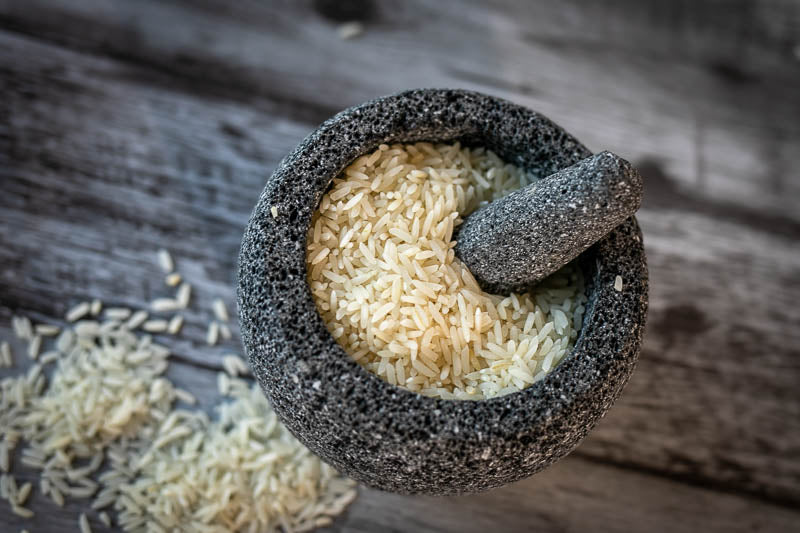 Small molcajete with uncooked rice.