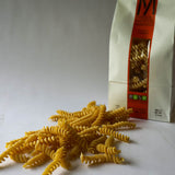 Dried Fusilli Lunghi Pasta in the background there's the bag as well. 