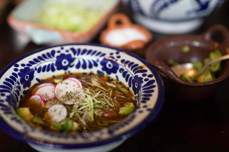 Rancho Gordo Red Chicken Pozole topped with radish and lettuce 