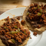 Two tacos with refried beans and chorizo topped with cut jalapeños - Rancho Gordo, Heirloom beans