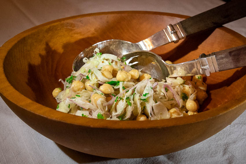 Rancho Gordo cooked Garbanzo beans, shaved fennel, onions, and herbs in a wooden bowl.