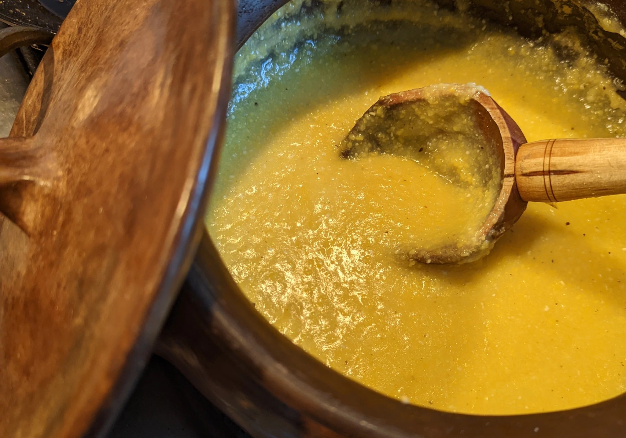 Rancho Gordo cooked Polenta in a pot with a wooden spoon