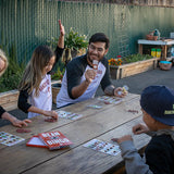 Rancho Gordo Female and male employee with three children playing the Rancho Gordo Bean Bingo