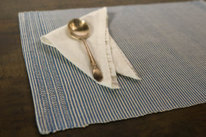 Natural Dye Placemat Set with a white napkin on top and a silver spoon 