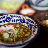 Red Posole dish topped with sliced radish, thinly cut cabbage - Rancho Gordo