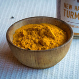 In a brown bowl there's the New Harvest Turmeric with the bottle behind