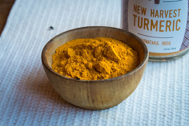 In a brown bowl there's the New Harvest Turmeric with the bottle behind