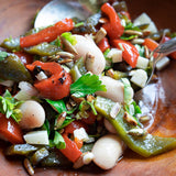 White beans, red and green peppers and parsely salad in a wooden bowl