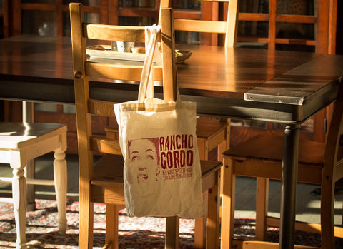 Rancho Gordo tote bag hanging from a chair in a dining table 
