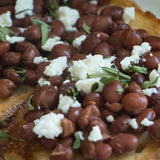 Santa Maria Pinquitos on top of toasted bread, topped with feta cheese, and a sprinkle of Oregano Indio - Rancho Gordo, Heirloom beans