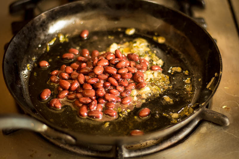 Domingo Rojo beans fried on a skillet with diced onions, Rancho Gordo-Heirloom beans